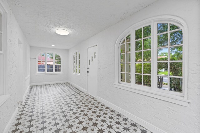 unfurnished room with a textured ceiling