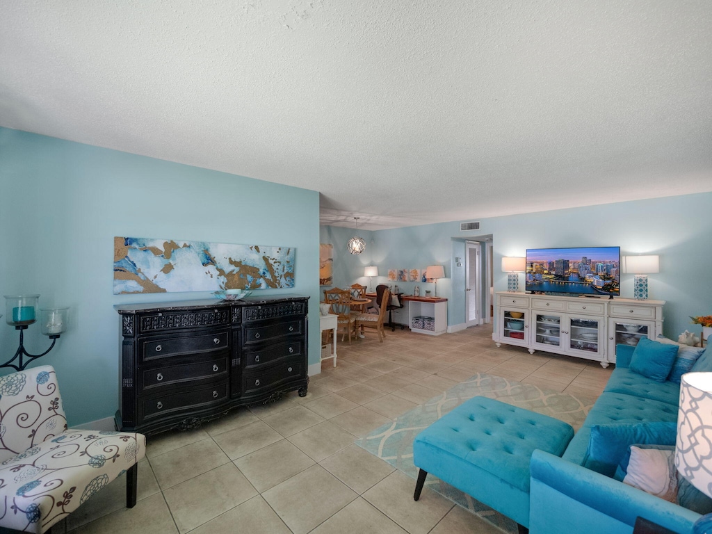 tiled living room with a textured ceiling