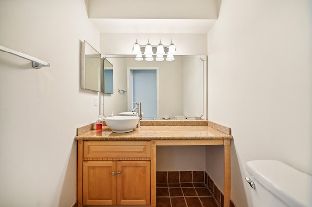 bathroom with tile patterned flooring, vanity, and toilet