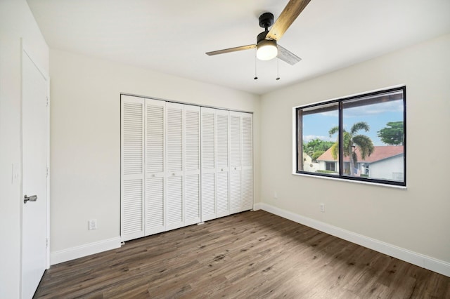 unfurnished bedroom featuring a closet, ceiling fan, and dark hardwood / wood-style floors