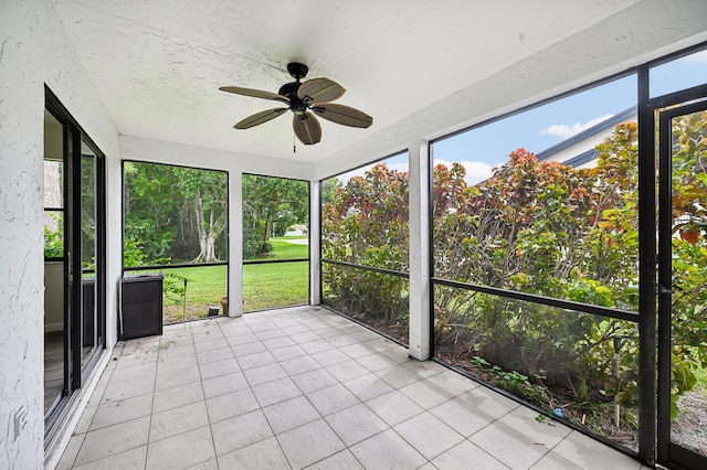 unfurnished sunroom featuring ceiling fan