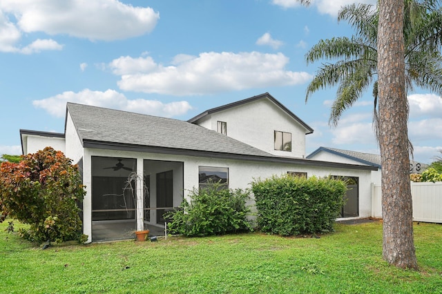 view of front of house with a front yard and a sunroom