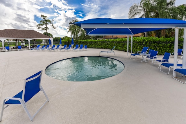 view of swimming pool featuring a gazebo and a patio