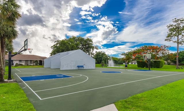 view of basketball court featuring a yard