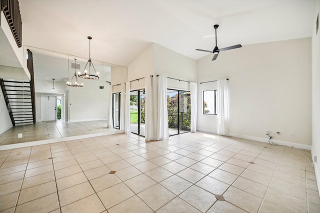 unfurnished room with ceiling fan with notable chandelier, light tile patterned floors, and high vaulted ceiling