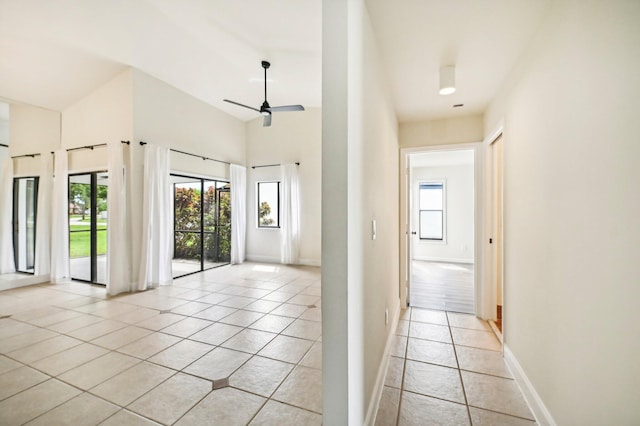 interior space with ceiling fan and a high ceiling