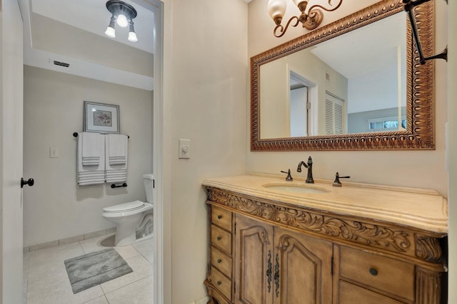 bathroom with tile patterned flooring, vanity, and toilet