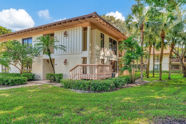 rear view of property featuring a lawn