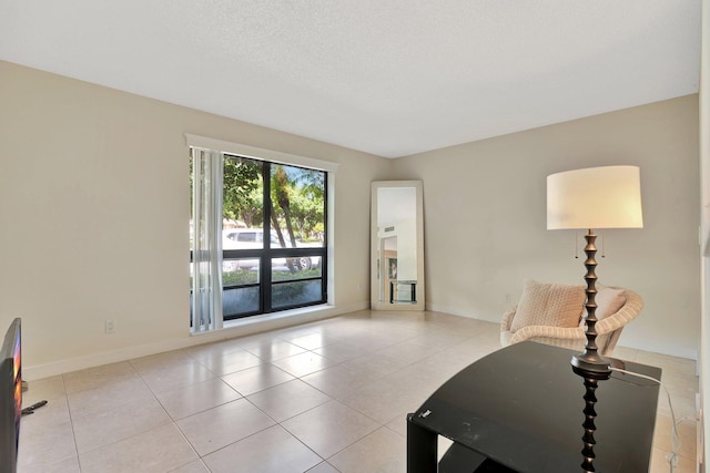 interior space featuring light tile patterned floors and a textured ceiling