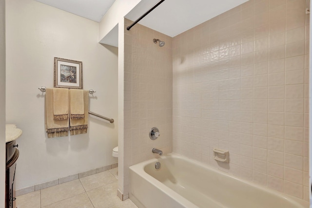 full bathroom featuring tile patterned flooring, vanity, toilet, and tiled shower / bath