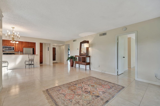 interior space with a chandelier and a textured ceiling