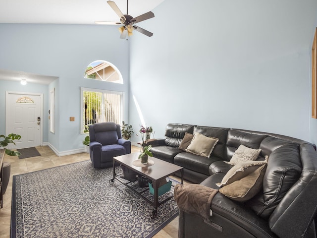 living room featuring ceiling fan, a towering ceiling, and light tile patterned floors