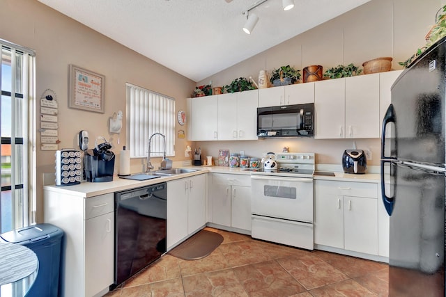 kitchen featuring white cabinets, a textured ceiling, black appliances, lofted ceiling, and sink