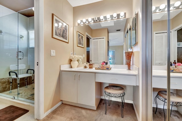 bathroom featuring walk in shower and vanity