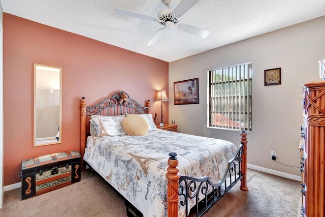 bedroom featuring a textured ceiling, carpet flooring, and ceiling fan