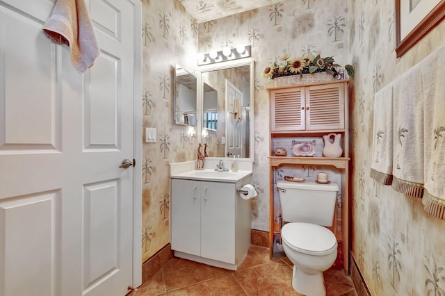 bathroom featuring tile patterned flooring, vanity, and toilet