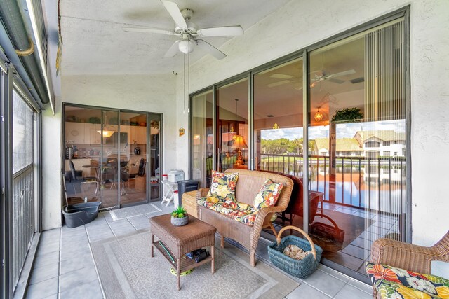 sunroom / solarium featuring lofted ceiling and ceiling fan