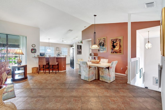 dining room featuring lofted ceiling