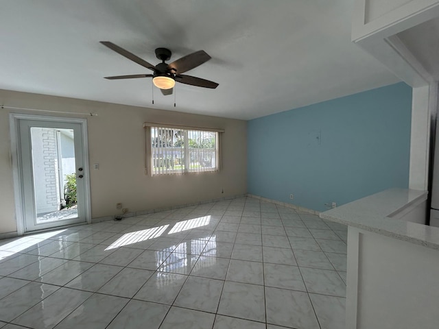 unfurnished living room with light tile patterned floors and ceiling fan