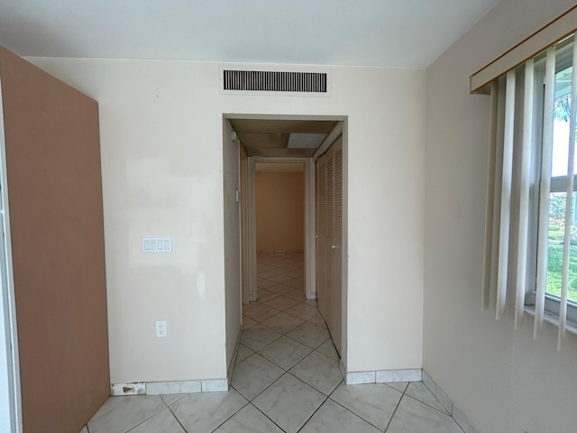 corridor featuring light tile patterned floors