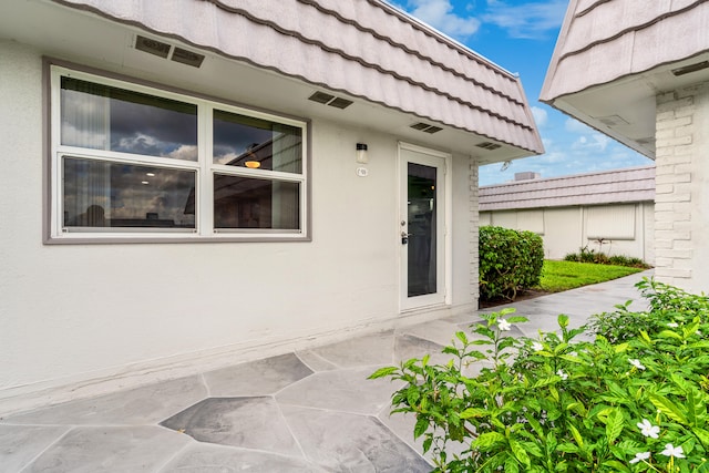 doorway to property with a patio