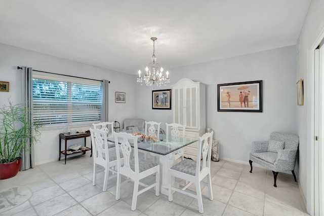 tiled dining room with a chandelier