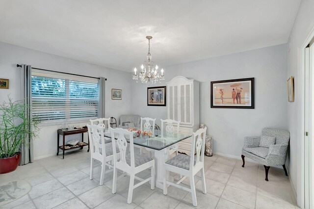 dining space featuring baseboards, light tile patterned flooring, and a notable chandelier