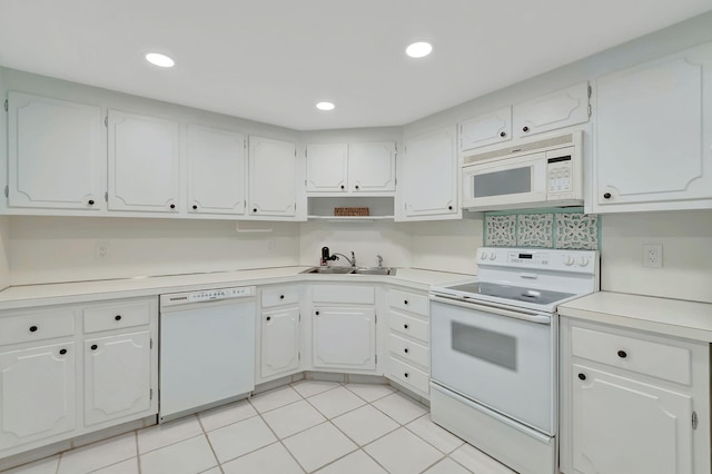 kitchen with white appliances, white cabinetry, sink, and light tile patterned flooring