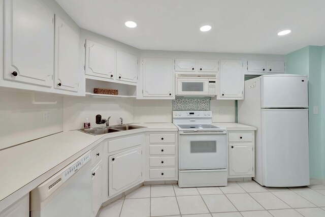 kitchen featuring a sink, white cabinets, white appliances, and light countertops
