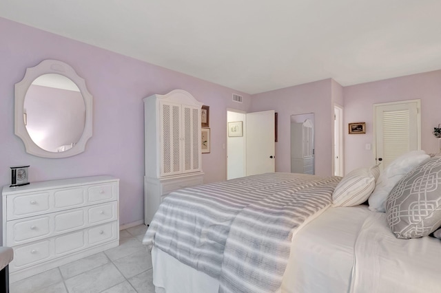 bedroom with light tile patterned floors