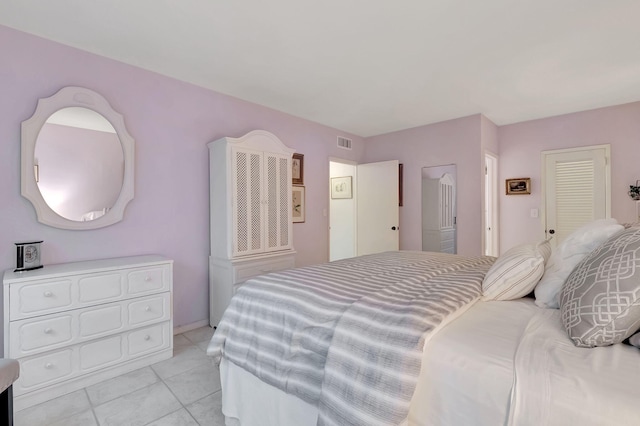 bedroom with light tile patterned floors and visible vents