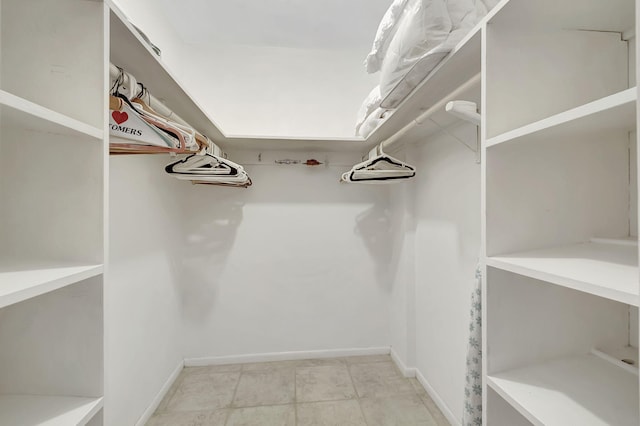 spacious closet featuring light tile patterned flooring