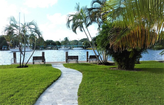 dock area featuring a lawn and a water view