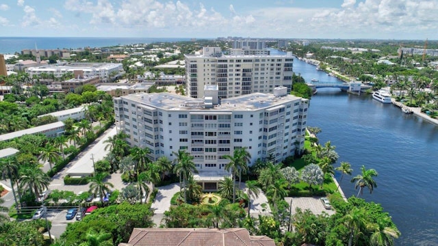 birds eye view of property with a water view and a city view