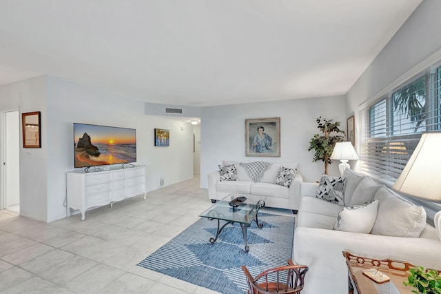 living room with light tile patterned floors and visible vents