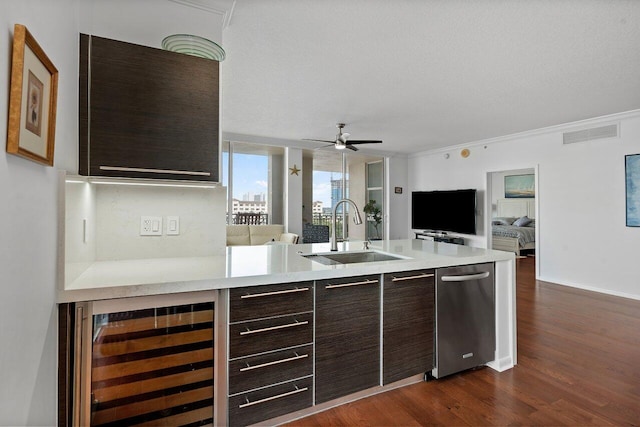 kitchen featuring dark brown cabinetry, wine cooler, decorative backsplash, sink, and dark hardwood / wood-style floors