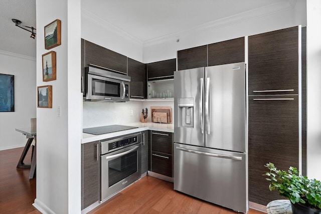 kitchen featuring stainless steel appliances, crown molding, light hardwood / wood-style flooring, and dark brown cabinetry