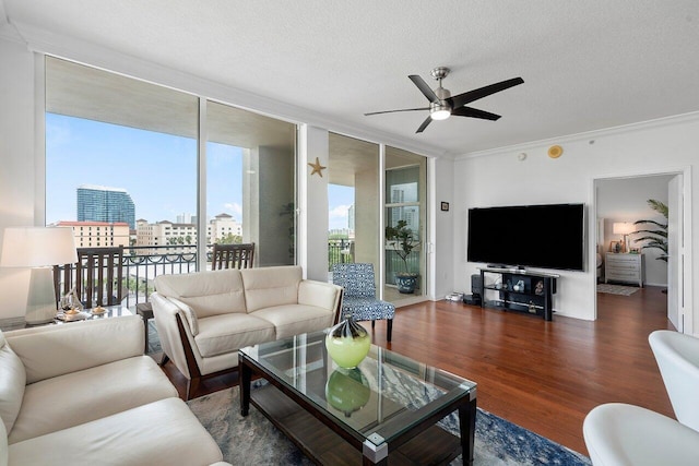 living room featuring ceiling fan, dark hardwood / wood-style floors, floor to ceiling windows, and a textured ceiling