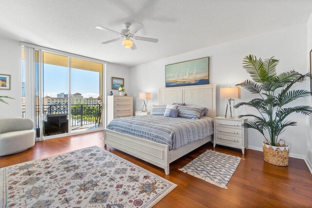 bedroom featuring ceiling fan, floor to ceiling windows, access to outside, dark wood-type flooring, and a textured ceiling