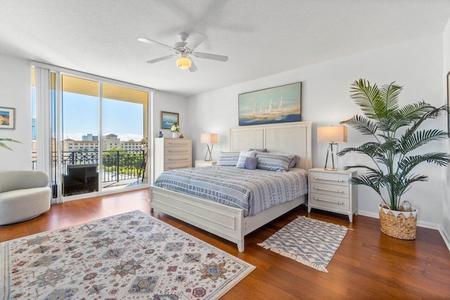 bedroom featuring dark wood-type flooring, floor to ceiling windows, a textured ceiling, access to outside, and ceiling fan