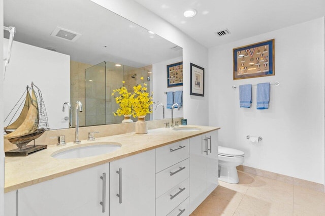 bathroom featuring tile patterned flooring, vanity, an enclosed shower, and toilet