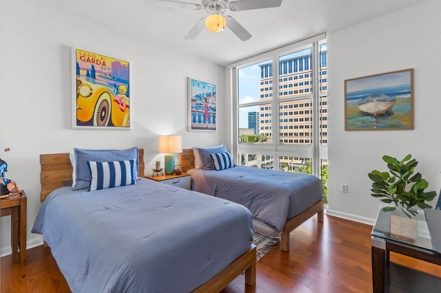 bedroom featuring ceiling fan, dark hardwood / wood-style floors, and floor to ceiling windows