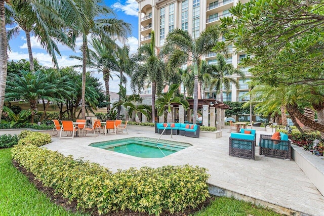 view of swimming pool featuring an in ground hot tub, outdoor lounge area, and a patio