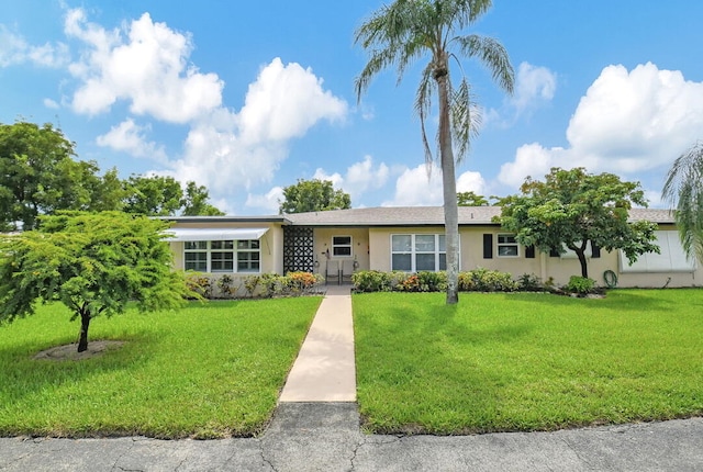 ranch-style house with a front lawn