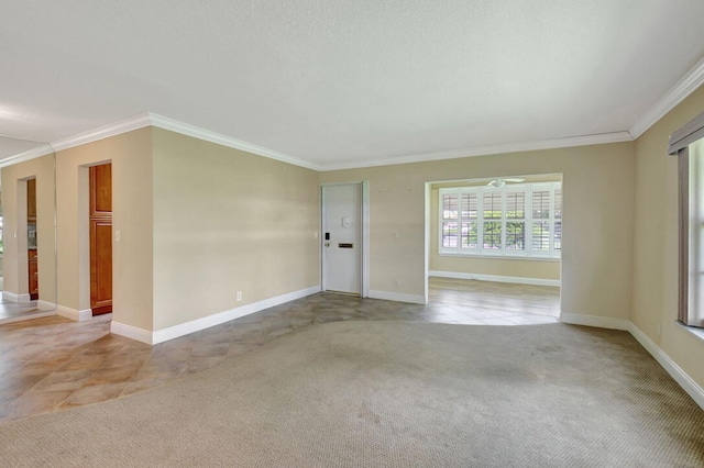 spare room with light carpet, ceiling fan, and ornamental molding