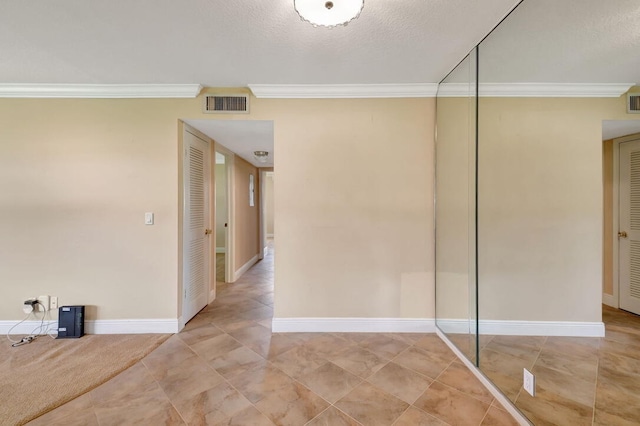 interior space with a textured ceiling and ornamental molding