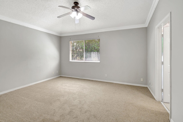 spare room featuring ceiling fan, light colored carpet, crown molding, and a textured ceiling