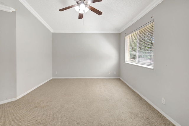 carpeted spare room with a textured ceiling, crown molding, and ceiling fan