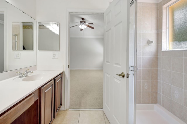 bathroom with ceiling fan, vanity, tile patterned floors, and tiled shower