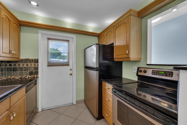 kitchen with light brown cabinets, appliances with stainless steel finishes, light tile patterned flooring, and tasteful backsplash